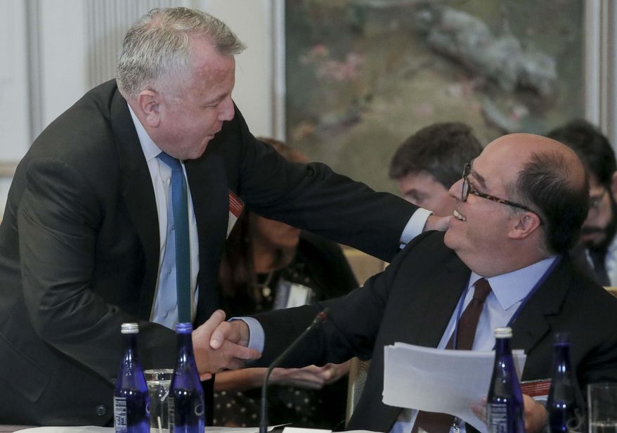 U.S. Deputy Secretary of State John Sullivan, left, and Julio Borges, an opposition leader in Venezuela, shake hands before a meeting organized by the OAS, to discuss sanctions on Venezuela, Monday Sept. 23, 2019, in New York. (AP Photo/Bebeto Matthews) ** FILE **