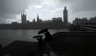 People are silhouetted with umbrellas in the rain backdropped by the Houses of Parliament in London, Tuesday, Sept. 24, 2019. In a major blow to Prime Minister Boris Johnson, Britain&#39;s highest court ruled Tuesday that his decision to suspend Parliament for five weeks in the crucial countdown to the country&#39;s Brexit deadline was illegal. (AP Photo/Matt Dunham)