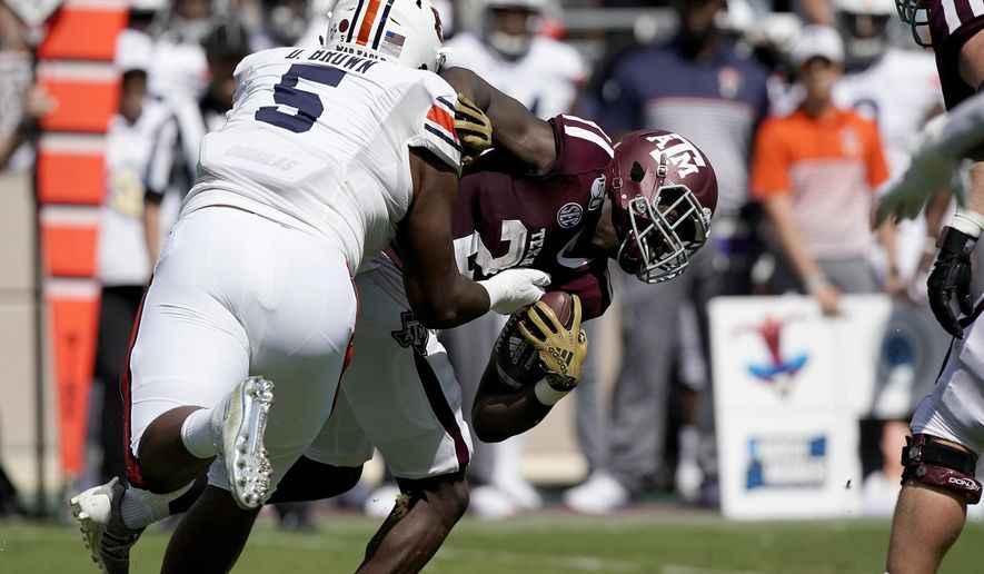 Auburn defensive tackle Derrick Brown (5) tackles Texas A&M running back Jacob Kibodi (23) for a loss during the first half of an NCAA college football game, Saturday, Sept. 21, 2019, in College Station, Texas. (AP Photo/Sam Craft)