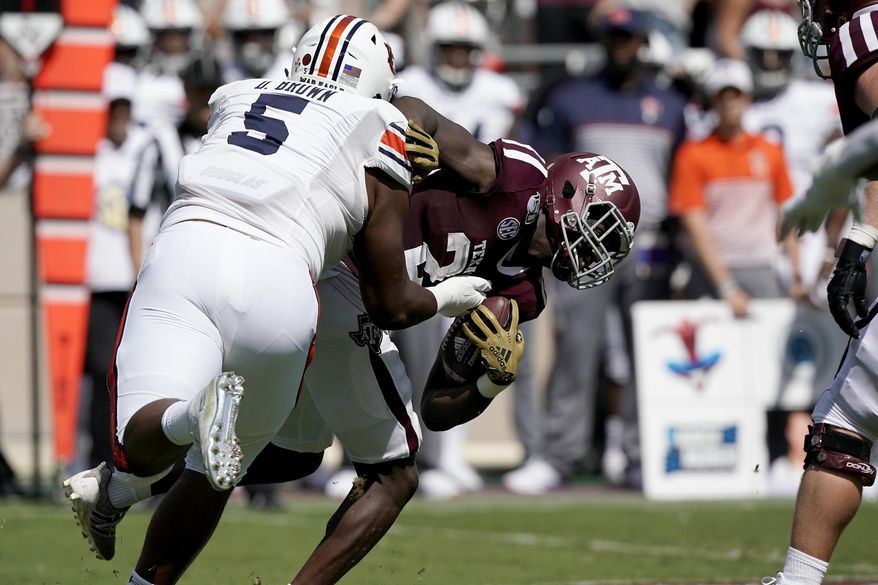 Auburn defensive tackle Derrick Brown (5) tackles Texas A&M running back Jacob Kibodi (23) for a loss during the first half of an NCAA college football game, Saturday, Sept. 21, 2019, in College Station, Texas. (AP Photo/Sam Craft)