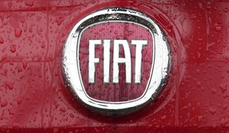 FILE - In this Thursday, Jan. 2, 2014 file photo, a Fiat logo pictured on a car in Milan, Italy. A top European court has ruled that automaker Fiat will have to pay up to 30 million euros, 33 million US dollars, in back taxes to Luxembourg. The Luxembourg-based General Court ruled Tuesday, Sept. 24, 2019, that the EU&#x27;s anti-trust regulator, the European Commission, had acted correctly in 2015 when it ordered Fiat Chrysler Finance Europe to return the tax break. (AP Photo/Antonio Calanni, File)
