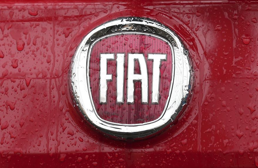 FILE - In this Thursday, Jan. 2, 2014 file photo, a Fiat logo pictured on a car in Milan, Italy. A top European court has ruled that automaker Fiat will have to pay up to 30 million euros, 33 million US dollars, in back taxes to Luxembourg. The Luxembourg-based General Court ruled Tuesday, Sept. 24, 2019, that the EU's anti-trust regulator, the European Commission, had acted correctly in 2015 when it ordered Fiat Chrysler Finance Europe to return the tax break. (AP Photo/Antonio Calanni, File)