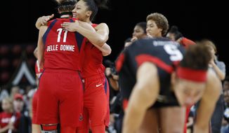 Washington Mystics&#39; Elena Delle Donne, left, and Aerial Powers celebrate after defeating the Las Vegas Aces in Game 4 of a WNBA playoff basketball series Tuesday, Sept. 24, 2019, in Las Vegas. (AP Photo/John Locher)