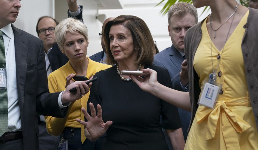 Speaker of the House Nancy Pelosi, D-Calif., is surrounded by reporters as she arrives to meet with her caucus the morning after declaring she will launch a formal impeachment inquiry against President Donald Trump, at the Capitol in Washington, Wednesday, Sept. 25, 2019. (AP Photo/J. Scott Applewhite)