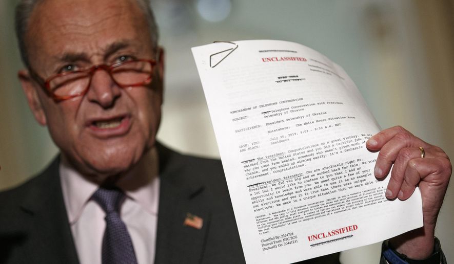 Senate Minority Leader Sen. Chuck Schumer of N.Y. holds up a copy of a White House released rough transcript of a phone call between President Donald Trump and the President of Ukraine as Schumer speaks to the media about an impeachment inquiry on President Trump, Wednesday Sept. 25, 2019, on Capitol Hill in Washington. (AP Photo/Jacquelyn Martin)