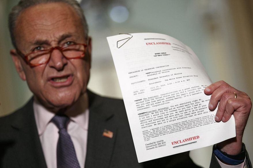 Senate Minority Leader Sen. Chuck Schumer of N.Y. holds up a copy of a White House released rough transcript of a phone call between President Donald Trump and the President of Ukraine as Schumer speaks to the media about an impeachment inquiry on President Trump, Wednesday Sept. 25, 2019, on Capitol Hill in Washington. (AP Photo/Jacquelyn Martin)