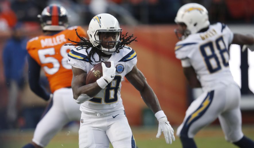 FILE - In this Dec. 30, 2018, file photo, Los Angeles Chargers running back Melvin Gordon rushes during the second half of the team&#39;s NFL football game against the Denver Broncos in Denver. A person familiar with the situation says Gordon will end his holdout and report to the Los Angeles Chargers on Thursday, Sept. 26. The person spoke to The Associated Press on condition of anonymity Wednesday because he wasn&#39;t at liberty to publicly discuss the situation. (AP Photo/David Zalubowski, File)