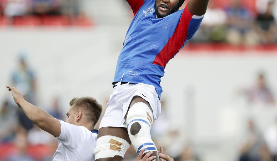 Namibia’s Tjiuee Uanivi catches the ball to to win a lineout against Italy during the Rugby World Cup Pool B game between Italy and Namibia in Osaka, western Japan, Sunday, Sept. 22, 2019. (Yohei Fukuyama/Kyodo News via AP)