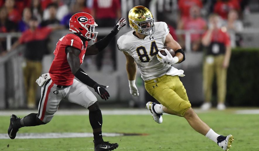 Notre Dame tight end Cole Kmet (84) runs against Georgia defensive back Divaad Wilson (1) during the first half of an NCAA college football game, Saturday, Sept. 21, 2019, in Athens, Ga. (AP Photo/Mike Stewart)