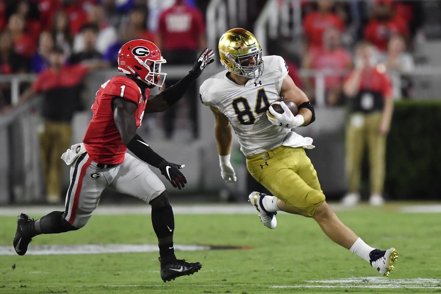 Notre Dame tight end Cole Kmet (84) runs against Georgia defensive back Divaad Wilson (1) during the first half of an NCAA college football game, Saturday, Sept. 21, 2019, in Athens, Ga. (AP Photo/Mike Stewart)