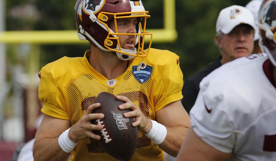 FILE - In this Monday, Aug. 5, 2019 file photo, Washington Redskins quarterback Colt McCoy (12) looks for a receiver during the Washington Redskins NFL football training camp in Richmond, Va. Case Keenum’s foot injury could put him in danger of starting at quarterback for the Washington Redskins on Sunday, Sept. 29, 2019 at the New York Giants. If Keenum can’t play, the 0-3 Redskins will either turn to Colt McCoy or ask first-round pick Dwayne Haskins to make his NFL debut. (AP Photo/Steve Helber, File)