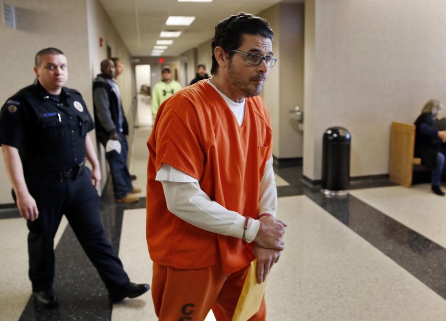 FILE - In this Jan. 8, 2018, file photo, Ronald Lee McMullen Jr. is led to the courtroom at Cleveland County District Court for a preliminary hearing in his first-degree murder case in Norman, Okla. McMullen's trial resumed Wednesday, Sept. 25, 2019. He is accused of fatally shooting his 22-year-old daughter in the face. (Steve Sisney/The Oklahoman via AP, File)