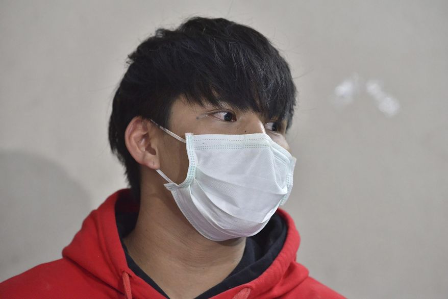 In this Sept. 18, 2019, photo, Ratchadech Wongtabut talks to reporters at the Bukkhalo Police Station in Bangkok, Thailand. Police have arrested Ratchadech the male model accused of taking an unconscious woman home, boasting online about his sexual exploits, and leaving her lifeless body in the lobby of his building. (AP Photo)