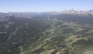 FILE - This June 16, 2015, aerial file photo, shows the Badger-Two Medicine area near the Blackfeet Indian Reservation and Glacier National Park, rear, in Montana. President Donald Trump&#39;s public lands steward, acting U.S. Bureau of Land Management Director William Perry Pendley, has recused himself from dealings with a company seeking to drill in the Badger-Two Medicine following criticism from U.S. Sen. Jon Tester and environmentalists. (Tristan Scott/Flathead Beacon via AP, File)