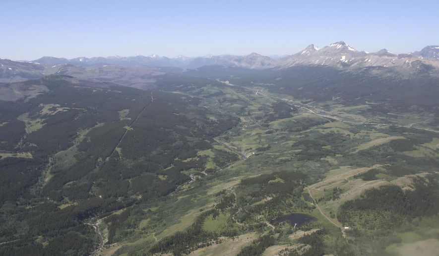 FILE - This June 16, 2015, aerial file photo, shows the Badger-Two Medicine area near the Blackfeet Indian Reservation and Glacier National Park, rear, in Montana. President Donald Trump&#x27;s public lands steward, acting U.S. Bureau of Land Management Director William Perry Pendley, has recused himself from dealings with a company seeking to drill in the Badger-Two Medicine following criticism from U.S. Sen. Jon Tester and environmentalists. (Tristan Scott/Flathead Beacon via AP, File)