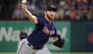 FILE - In this  Friday, Aug. 16, 2019 file photo, Minnesota Twins relief pitcher Sam Dyson throws to the Texas Rangers in the seventh inning of a baseball game in Arlington, Texas. Minnesota reliever Sam Dyson had surgery on his shoulder, ending the right-hander&#39;s season and potentially putting 2020 in jeopardy as well. Dyson had the capsule repair operation Tuesday, Sept. 24, 2019 in California. (AP Photo/Tony Gutierrez, File)