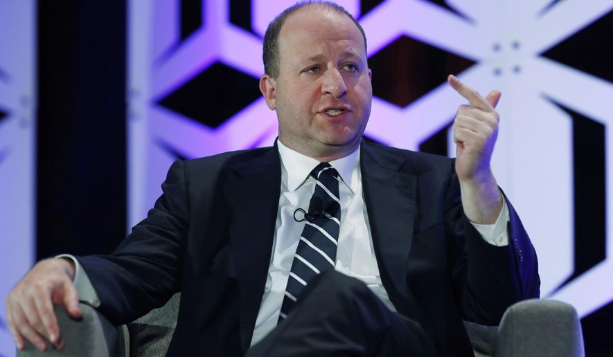 FILE - In this Aug. 28, 2019, file photo, Colorado Gov. Jared Polis speaks during an appearance at The Energy Summit in Denver. The press operation for Polis, Colorado's liberal Democratic governor, is being criticized after it asked two small town newspapers to remove from their websites a news story reported by what Polis' staff deems a biased news organization funded by groups affiliated with the conservative Koch family. (AP Photo/David Zalubowski, File)