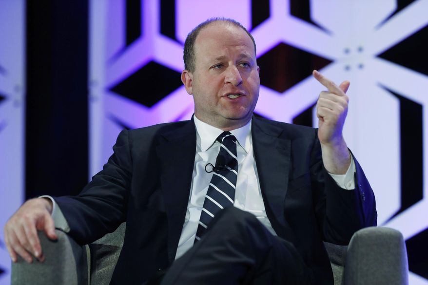 FILE - In this Aug. 28, 2019, file photo, Colorado Gov. Jared Polis speaks during an appearance at The Energy Summit in Denver. The press operation for Polis, Colorado's liberal Democratic governor, is being criticized after it asked two small town newspapers to remove from their websites a news story reported by what Polis' staff deems a biased news organization funded by groups affiliated with the conservative Koch family. (AP Photo/David Zalubowski, File)