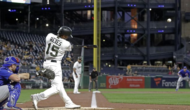 Pittsburgh Pirates&#x27; Pablo Reyes (15) drives in two runs with a triple off Chicago Cubs starting pitcher Jose Quintana during the first inning of a baseball game in Pittsburgh, Thursday, Sept. 26, 2019. (AP Photo/Gene J. Puskar)