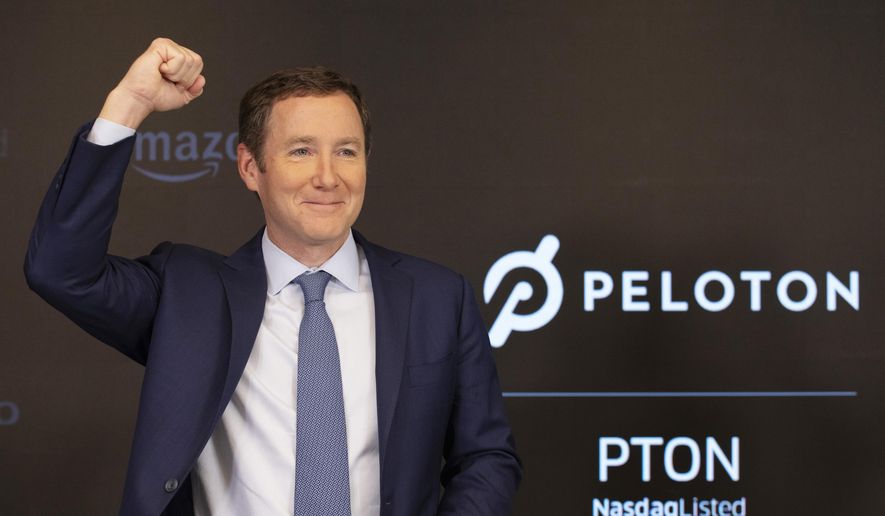 Peloton CEO John Foley celebrates at the Nasdaq MarketSite before the opening bell and his company's IPO, Thursday, Sept. 26, 2019 in New York. (AP Photo/Mark Lennihan)