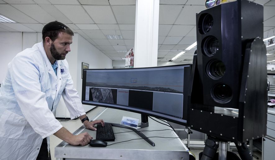 In this Monday, Sept. 9, 2019 photo, Ariel Gomez, a systems engineer at Israel Aerospace Industries, works on the Popstar system that can track and identify flying objects day or night without being detected, at Israel Aerospace Industries, in the Israeli town of Yehud near Tel Aviv. Israel has long been a dominant player in the military drone export business, developing small attack aircraft as well as long-range spy planes. Now, Israeli firms are at the forefront of a global industry developing means to protect against the drone threat. (AP Photo/Tsafrir Abayov)