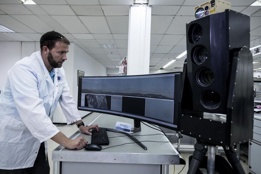 In this Monday, Sept. 9, 2019 photo, Ariel Gomez, a systems engineer at Israel Aerospace Industries, works on the Popstar system that can track and identify flying objects day or night without being detected, at Israel Aerospace Industries, in the Israeli town of Yehud near Tel Aviv. Israel has long been a dominant player in the military drone export business, developing small attack aircraft as well as long-range spy planes. Now, Israeli firms are at the forefront of a global industry developing means to protect against the drone threat. (AP Photo/Tsafrir Abayov)