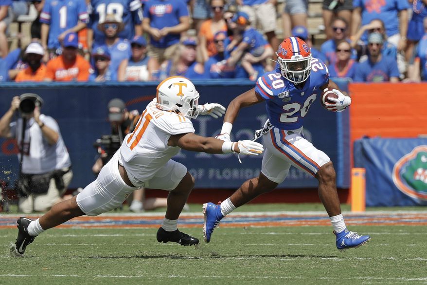 Florida running back Malik Davis (20) tries to get past Tennessee linebacker Henry To'o To'o, left, during the first half of an NCAA college football game, Saturday, Sept. 21, 2019, in Gainesville, Fla. (AP Photo/John Raoux)
