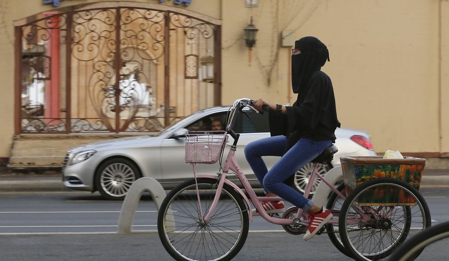 A Saudi woman rides her bicycle, in Jiddah, Saudi Arabia, Friday, Sept. 27, 2019. (AP Photo/Amr Nabil)