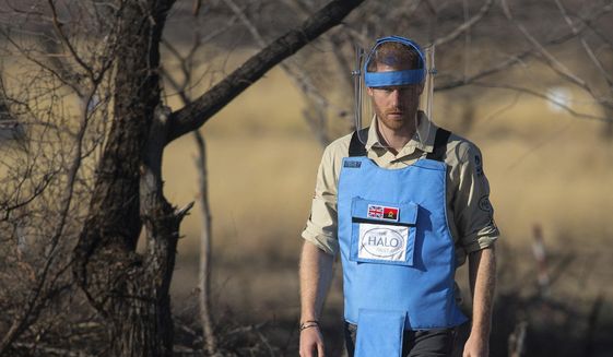 Britain&#39;s Prince Harry walks through a minefield in Dirico, Angola Friday Sept. 27, 2019, during a visit to see the work of landmine clearance charity the Halo Trust, on day five of the royal tour of Africa. Prince Harry is following in the footsteps of his late mother, Princess Diana, whose walk through an active mine field in Angola years ago helped to lead to a global ban on the deadly weapons. (Dominic Lipinski/Pool via AP)