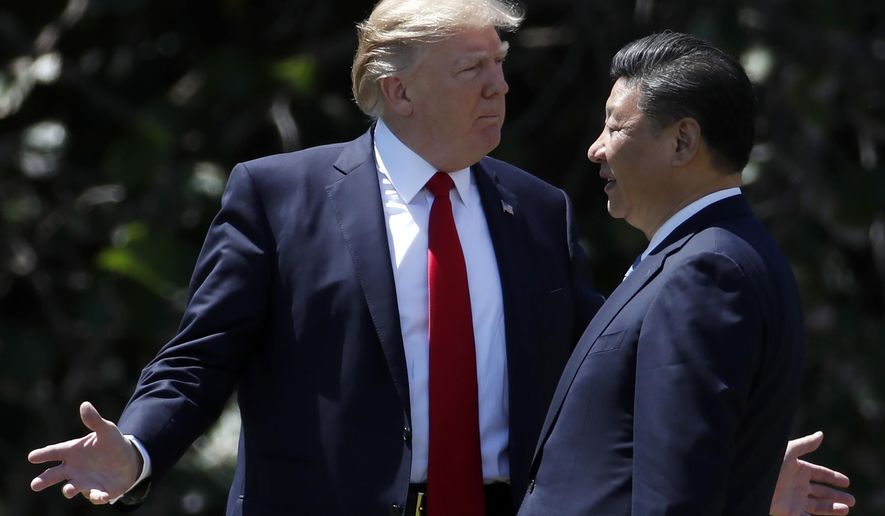 FILE - In this April 7, 2017, file photo, U.S. President Donald Trump gestures as he and Chinese President Xi Jinping walk together after their meetings at Mar-a-Lago, in Palm Beach, Fla. Trump started a tariff and trade war with China as concern grows over China’s challenge to U.S. technological might. (AP Photo/Alex Brandon, File)