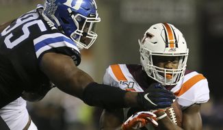 Virginia Tech&#39;s James Mitchell (82) is stopped at the 2-yard line by Duke defender Trevon McSwain (95) in the first quarter of an NCAA college football game, Friday, Sept. 27, 2019, in Blacksburg, Va. (Matt Gentry/The Roanoke Times via AP) **FILE**