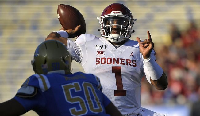 Oklahoma quarterback Jalen Hurts, right, throws a pass as UCLA defensive lineman Tyler Manoa defends during the first half of an NCAA college football game Saturday, Sept. 14, 2019, in Pasadena, Calif. (AP Photo/Mark J. Terrill)