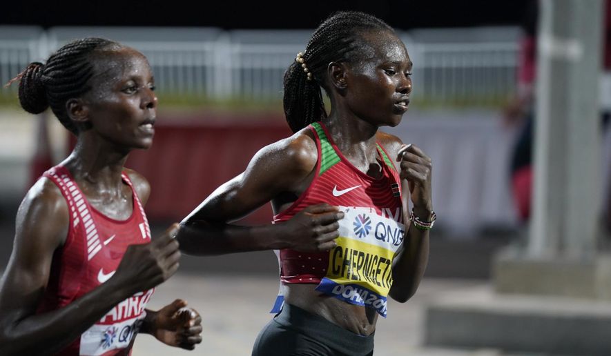 Ruth Chepngetich, of Kenya, right, leads Rose Chelimo, of Bahrain, during the women's marathon at the World Athletics Championships in Doha, Qatar, Saturday, Sept. 28, 2019. Chepngetich won the marathon. (AP Photo/Nick Didlick, Pool)