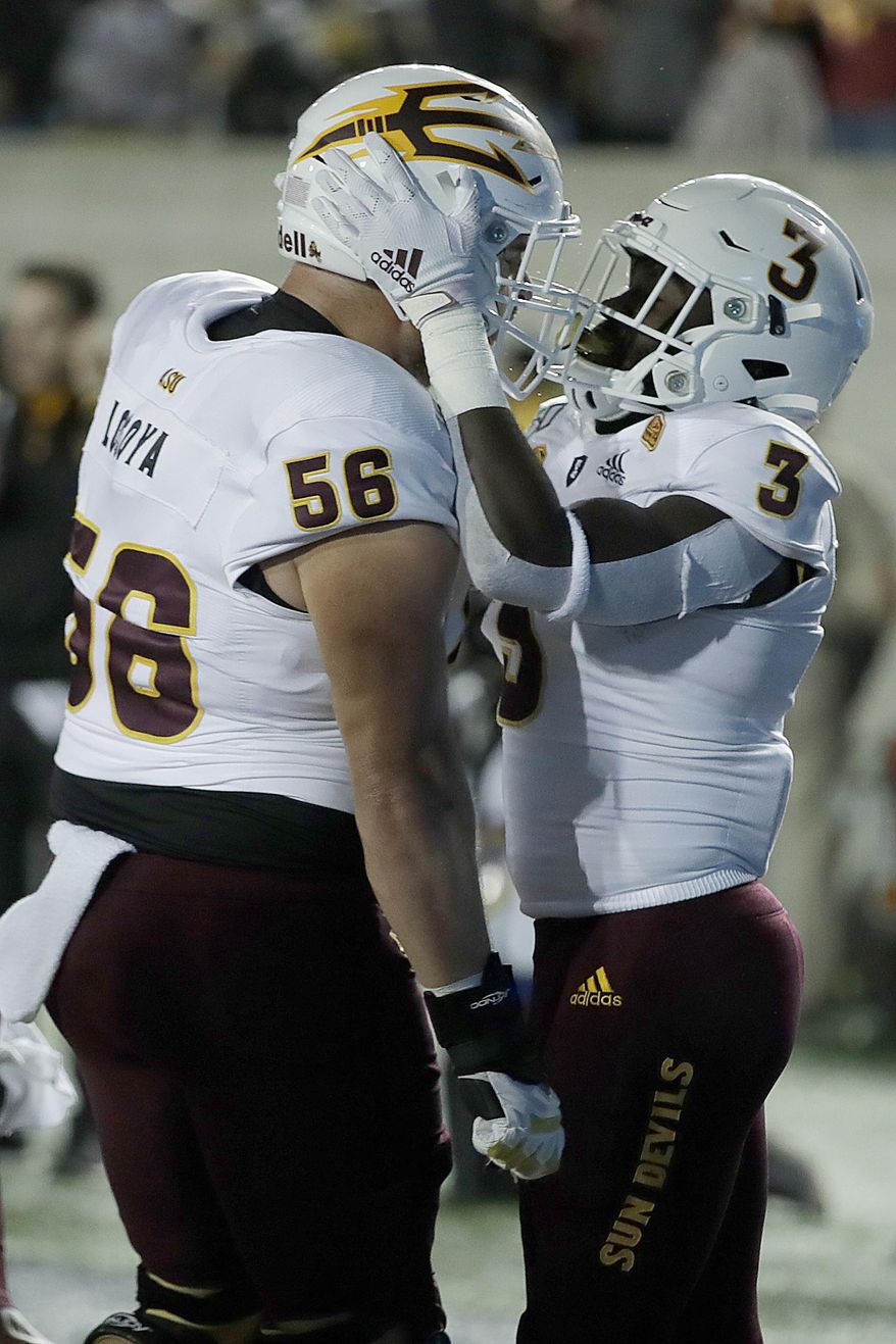 Arizona State's Eno Benjamin, right, celebrates with Alex Losoya (56) after scoring a touchdown against California in the first half of an NCAA college football game, Friday, Sept. 27, 2019, in Berkeley, Calif. (AP Photo/Ben Margot)