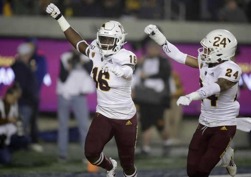 Arizona State's Aashari Crosswell, left, celebrates with Chase Lucas (24) after intercepting a pass intended for California's Jordan Duncan in the first half of an NCAA college football game, Friday, Sept. 27, 2019, in Berkeley, Calif. (AP Photo/Ben Margot)