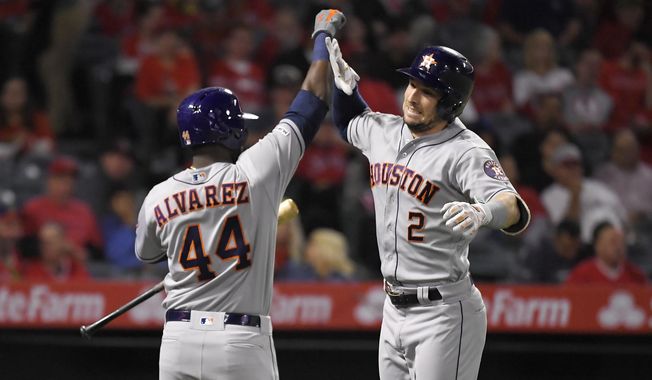 Houston Astros&#x27; Alex Bregman, right, is congratulated by Yordan Alvarez after hitting a solo home run during the second inning of a baseball game against the Los Angeles Angels, Friday, Sept. 27, 2019, in Anaheim, Calif. (AP Photo/Mark J. Terrill)