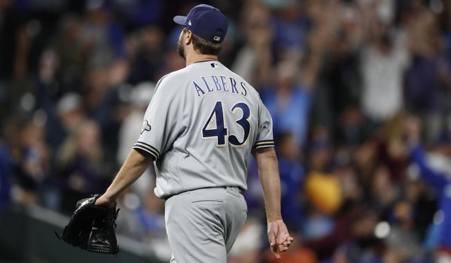 Milwaukee Brewers relief pitcher Matt Albers heads off the mound after giving up a solo walkoff home run to Colorado Rockies&#x27; Trevor Story in the 10th inning of a baseball game Saturday, Sept. 28, 2019, in Denver. (AP Photo/David Zalubowski)