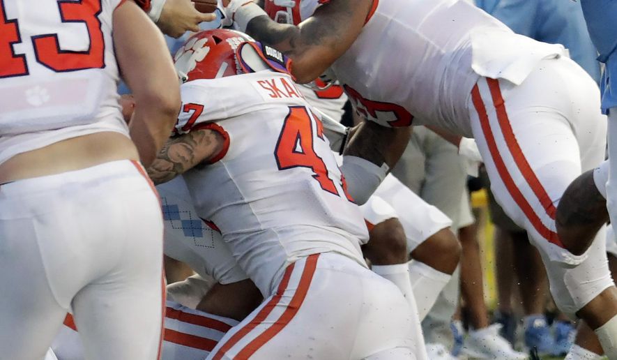 North Carolina's Sam Howell (7) gets stopped on a two-point conversion by Clemson's James Skalski (47) and Xavier Thomas (3) in the fourth quarter of an NCAA college football game in Chapel Hill, N.C., Saturday, Sept. 28, 2019. (AP Photo/Chris Seward)