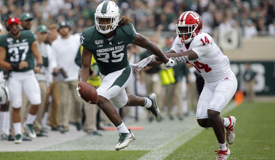 Michigan State receiver Darrell Stewart, left, is pushed out of bounds by Indiana's Andre Brown (14) after a pass reception during the first quarter of an NCAA college football game, Saturday, Sept. 28, 2019, in East Lansing, Mich. (AP Photo/Al Goldis)