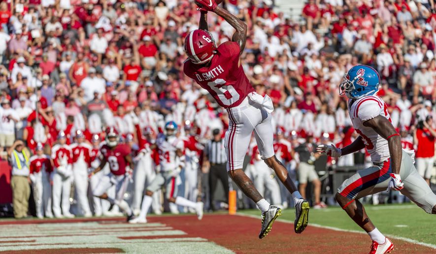 Alabama wide receiver DeVonta Smith (6) leaps into the air for his fourth touchdown reception well ahead of coverage from Mississippi defensive back Keidron Smith (20) during the first half of an NCAA college football game, Saturday, Sept. 28, 2019, in Tuscaloosa, Ala. (AP Photo/Vasha Hunt)
