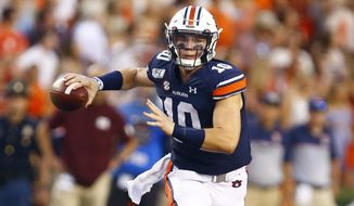 Auburn quarterback Bo Nix (10) rolls out to pass during the first half of an NCAA college football game against Mississippi State, Saturday, Sept. 28, 2019, in Auburn, Ala. (AP Photo/Butch Dill)