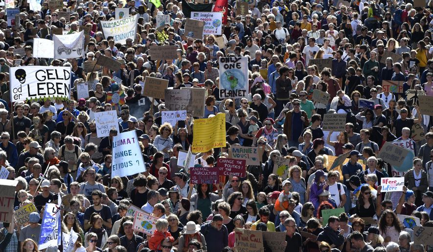 People attend a 'National Climate Strike' demonstration in Bern, Switzerland, Saturday, Sept. 28, 2019. Thousands of people, young and old, are staging a protest in the Swiss capital Bern calling for more action to curb climate change. (Anthony Anex/Keystone via AP)
