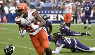 Cleveland Browns running back Nick Chubb (24) prepares to cross the goal line after avoiding several tackles from Baltimore Ravens defenders during the second half of an NFL football game Sunday, Sept. 29, 2019, in Baltimore. (AP Photo/Brien Aho)