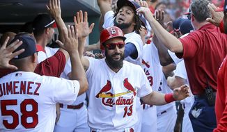 St. Louis Cardinals&#39; Matt Carpenter, center, is congratulated by teammates after hitting a three-run home run during the third inning of a baseball game against the Chicago Cubs Sunday, Sept. 29, 2019, in St. Louis. (AP Photo/Scott Kane)