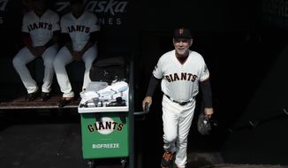 San Francisco Giants manager Bruce Bochy walks into the dugout before a baseball game between the Giants and the Los Angeles Dodgers in San Francisco, Sunday, Sept. 29, 2019. (AP Photo/Jeff Chiu)