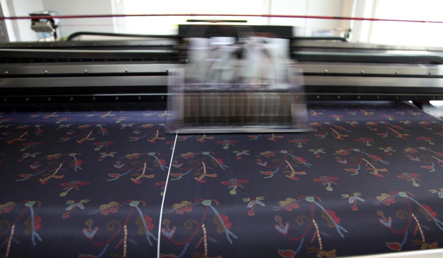 In this Tuesday, Sept. 10, 2019, a silk digital printing machine operates at Silk Tsiakiris Company in Soufli, northeastern Greece. Greece's financial crisis nearly snuffed out the country's centuries-old silk manufacturing tradition, but the end of the crippling recession has raised demand for fashion products and silk produced by a remote border town. (AP Photo/Iliana Mier)