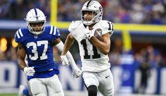 Oakland Raiders wide receiver Trevor Davis (11) runs in fro a touchdown in from of Indianapolis Colts safety Khari Willis (37) during the first half of an NFL football game in Indianapolis, Sunday, Sept. 29, 2019. (AP Photo/Doug McSchooler)