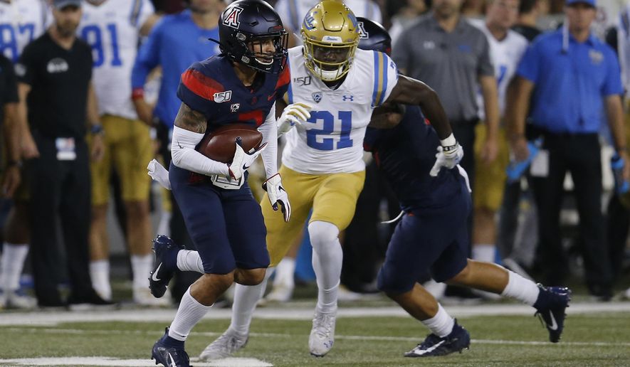 Arizona cornerback Lorenzo Burns (2) runs with the ball after intercepting a pass against UCLA in the first half during an NCAA college football game, Saturday, Oct. 28, 2019, in Tucson, Ariz. (AP Photo/Rick Scuteri)