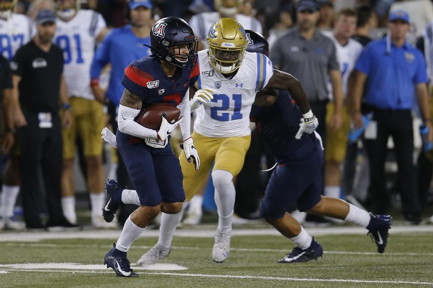 Arizona cornerback Lorenzo Burns (2) runs with the ball after intercepting a pass against UCLA in the first half during an NCAA college football game, Saturday, Oct. 28, 2019, in Tucson, Ariz. (AP Photo/Rick Scuteri)