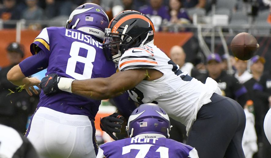 Minnesota Vikings quarterback Kirk Cousins (8) fumbles the ball as he is sacked for a 7-yard loss by Chicago Bears outside linebacker Khalil Mack, right, during the second half of an NFL football game Sunday, Sept. 29, 2019, in Chicago. The Bears recovered the fumble. (AP Photo/Matt Marton)
